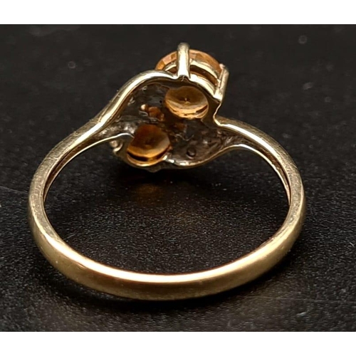 518 - A 9K Yellow Gold Citrine and Diamond Ring. Size K 1/2.
1.68g total weight.