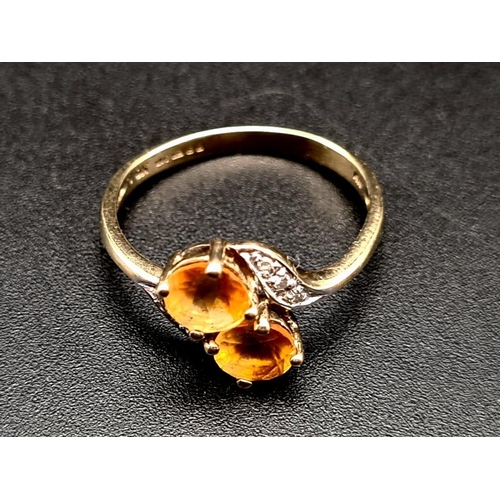 518 - A 9K Yellow Gold Citrine and Diamond Ring. Size K 1/2.
1.68g total weight.