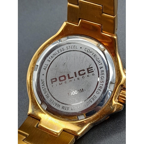 237 - A Police Gold Plated Watch. Gold plated strap and case - 38mm. White stone decorated bezel. White an... 