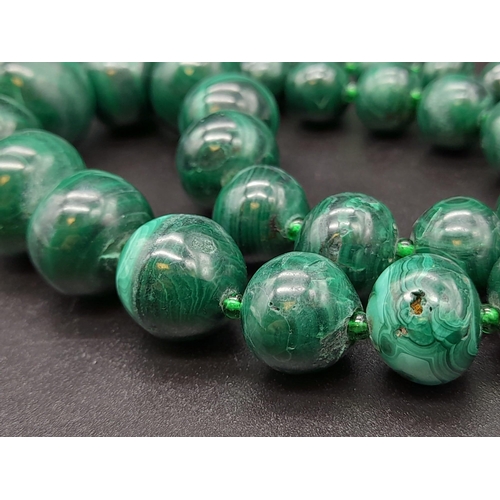 651 - A Vintage Graduated Malachite Bead Necklace. 20mm largest bead. Barrel clasp. 60cm