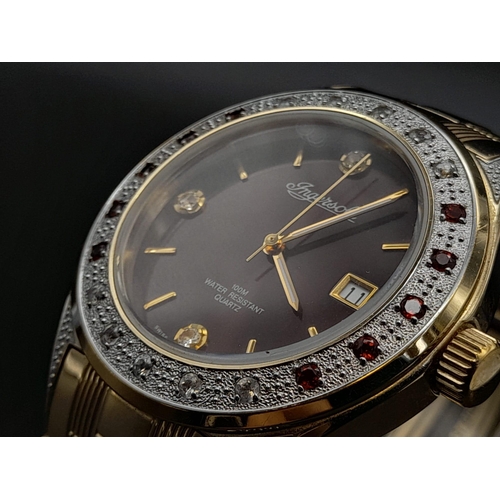 70 - A Gem Encrusted Ingersoll Quartz Watch. Gold plated strap and case - 40mm. Red and white gemstone en... 