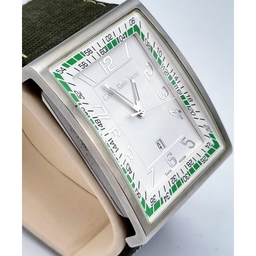 392 - A Calvin Klein Jeans Large Faced Watch. Green cloth strap. Stainless steel case - 50 x 42mm. White d... 