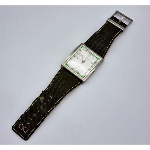 392 - A Calvin Klein Jeans Large Faced Watch. Green cloth strap. Stainless steel case - 50 x 42mm. White d... 