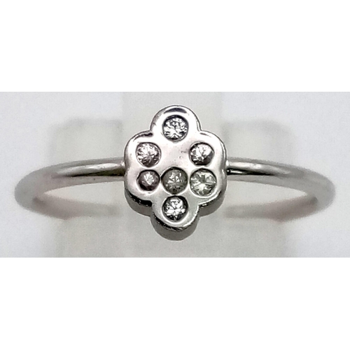 728 - A 9K Rhodium plated ring with an array of white sapphires. Total weight: 1.97 grams. Size: L