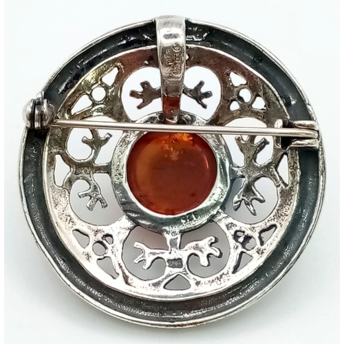 1020 - A Vintage Amber and Silver Pendant/Brooch. 4cm diameter.