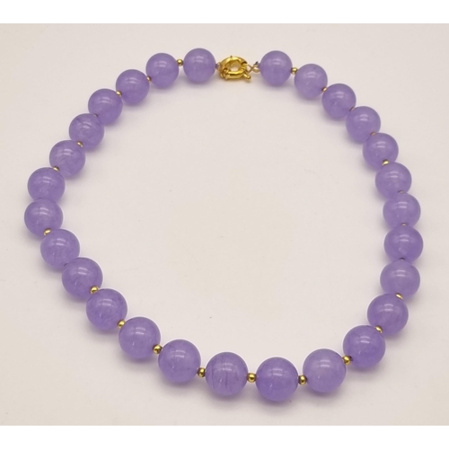 1081 - A Lavender Jade Beaded Necklace. Gilded spacers and clasp. 42cm