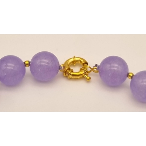 1081 - A Lavender Jade Beaded Necklace. Gilded spacers and clasp. 42cm