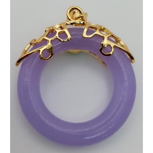 1110 - A Lavender Jade Doughnut Pendant with Gilded Setting. 3cm.