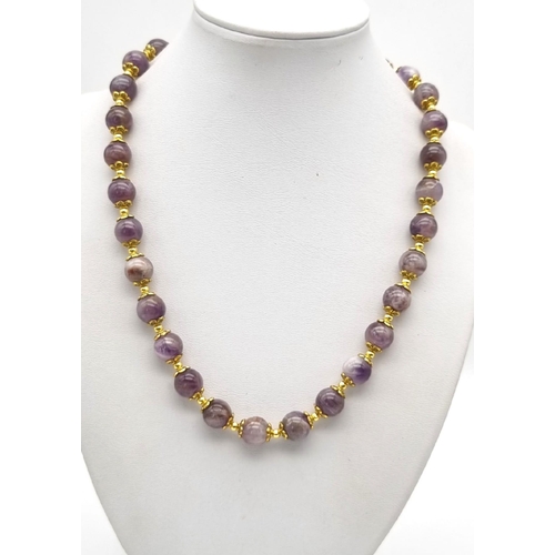 1112 - A Blue John Beaded Necklace. Gilded spacers and clasp. 
44cm. 10mm beads.