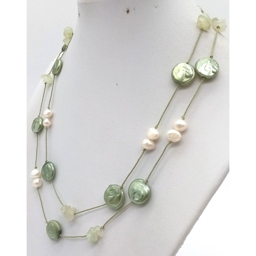 1114 - A Green Coin Pearl and Seed Pearl Opera Necklace.  80cm