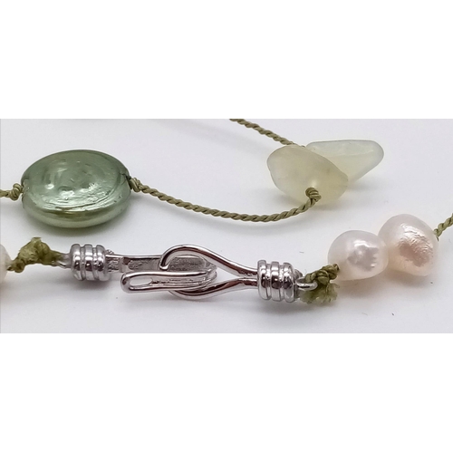 1114 - A Green Coin Pearl and Seed Pearl Opera Necklace.  80cm