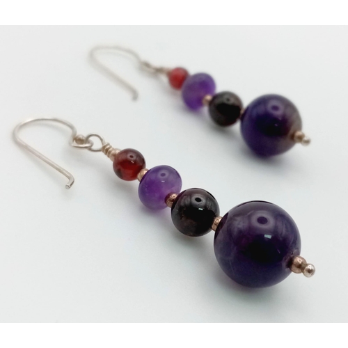 1127 - A Pair of Graduated Purple Gemstone Earrings. 4cm.