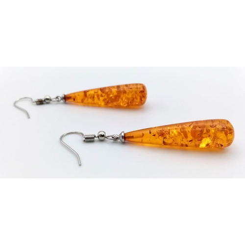 1128 - An Amber-Coloured Resin Pair of Teardrop Earrings. 4cm.