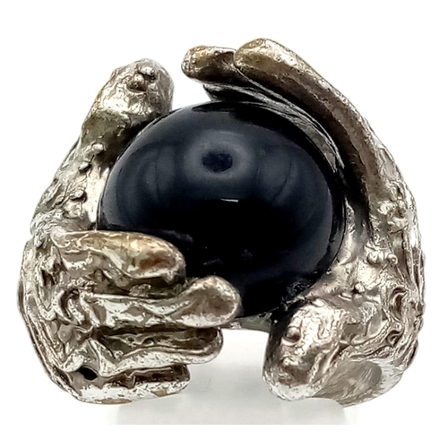 1167 - A Black Onyx White Metal Ring. Size N.