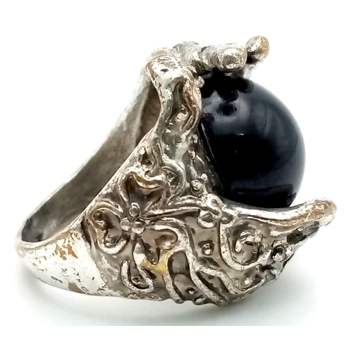 1167 - A Black Onyx White Metal Ring. Size N.