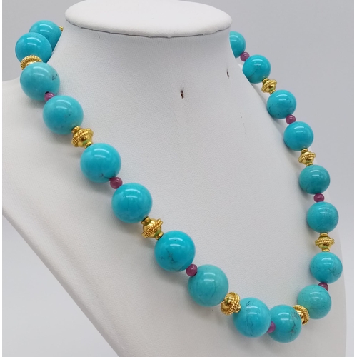 932 - A Large Turquoise Beaded and Natural Ruby Necklace. Gold plated spacers and clasp. 44cm.