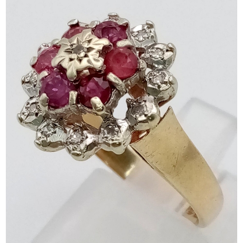 954 - A 9K Yellow Gold Ruby and Diamond Floral Ring. Six rubies and thirteen diamonds. Size N. 4.16g total... 