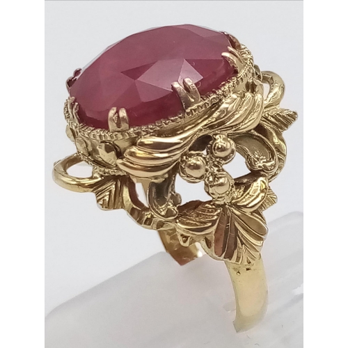 964 - A Hand-Crafted 14K Yellow Gold Large Ruby Ring. Large central faceted oval ruby - 15ct. Size N. 7.46... 