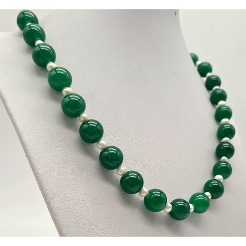 1021 - A Jade and Seed Pearl Necklace. 10mm jade beads,