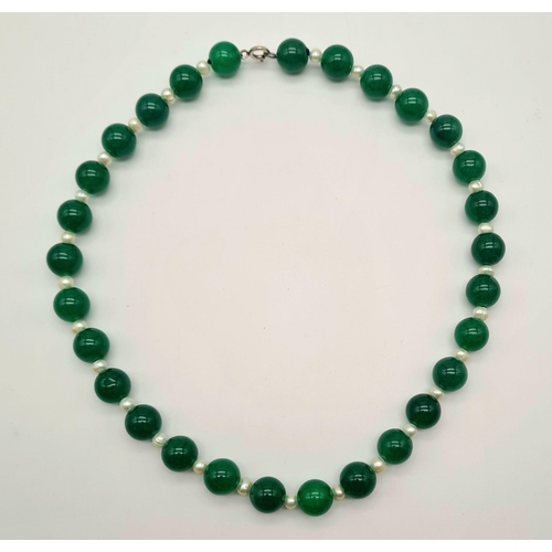 1021 - A Jade and Seed Pearl Necklace. 10mm jade beads,