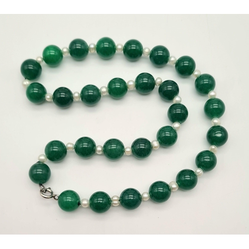 1021 - A Jade and Seed Pearl Necklace. 10mm jade beads,