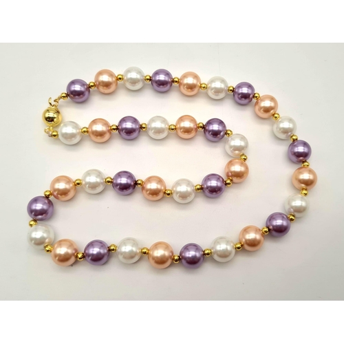 986 - A Multi-Coloured Cultured Pearl Necklace. Gilded spacers and clasp. 10mm pearls. 42cm.