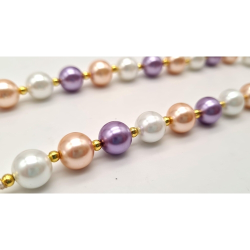 986 - A Multi-Coloured Cultured Pearl Necklace. Gilded spacers and clasp. 10mm pearls. 42cm.