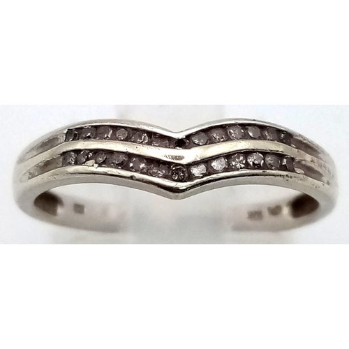 555 - A 10K White Gold Diamond Chevron Ring. Size M 1/2.
1.7g total weight.