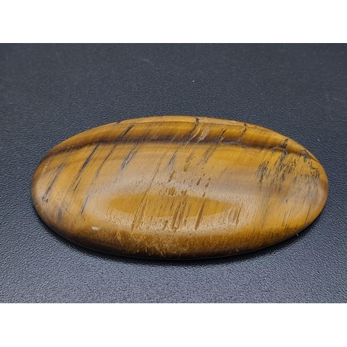 923 - An oval cabochon tiger's eye (44.53 carats) with AIG Milan certificate. Dimensions: 42.00 x 24.10 x ... 