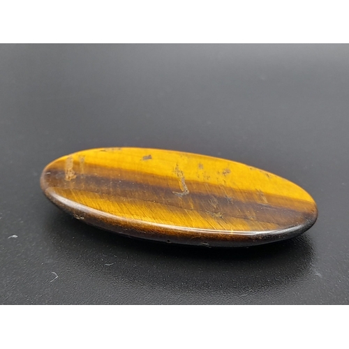 923 - An oval cabochon tiger's eye (44.53 carats) with AIG Milan certificate. Dimensions: 42.00 x 24.10 x ... 