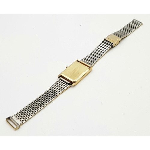 838 - A Vintage Avia 9K Gold Cased Watch. Gilded strap. Gold rectangular case - 33 x 23mm. Dial is worn on... 