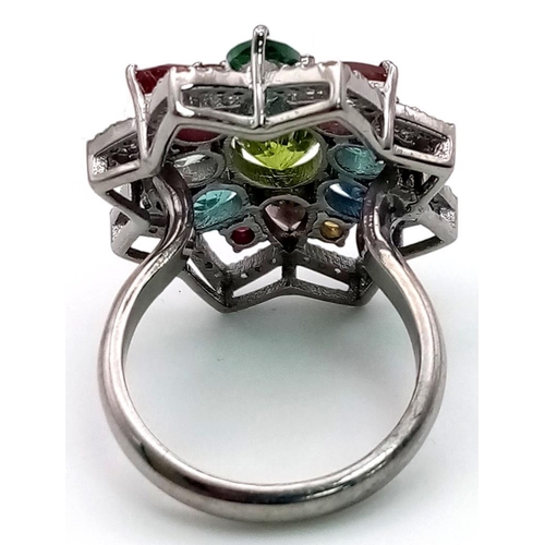 1069 - A Peridot Gemstone Ring with Peridot 2.45ct - with a halo of diamonds .50ct and Tourmalines 3.50ct. ... 