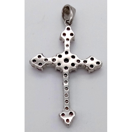 1183 - A 9K White Gold Cross Pendant with Pink Topaz and White Stones. 3.5 x 2.5cm. 4.53g total weight.