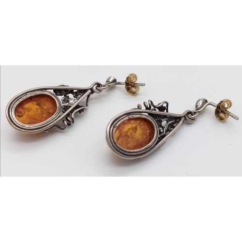 1184 - A Pair of Vintage Silver and Amber Cabochon Earrings.