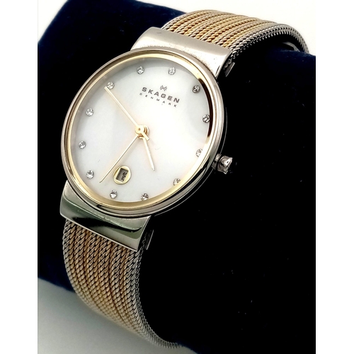 1023 - A Skagen of Denmark Ladies Watch. Two tone strap. Case - 26mm. White dial with 12 white stones and d... 