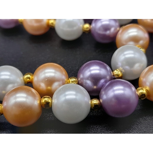 1198 - A Multi-Coloured Cultured Pearl Necklace. Gilded spacers and clasp. 44cm