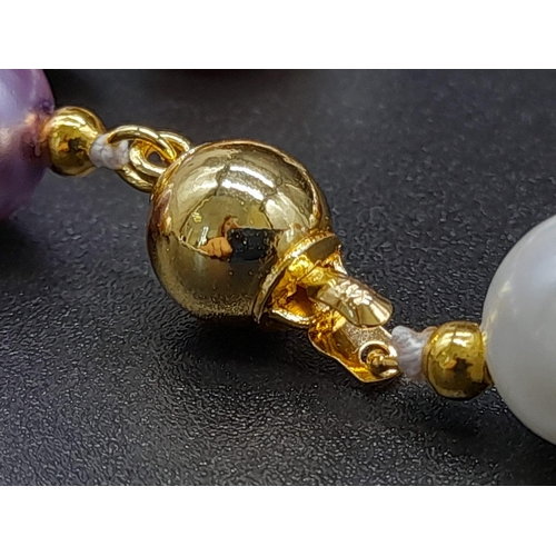 1198 - A Multi-Coloured Cultured Pearl Necklace. Gilded spacers and clasp. 44cm