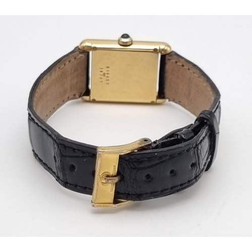 843 - A Baume and Mercier 18K Gold Ladies Tank Watch. Leather strap. 18K gold case - 27 x 22mm. Mechanical... 