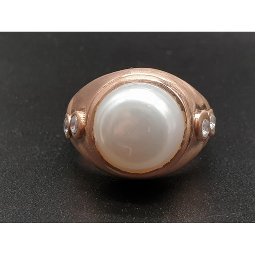 1058 - A 10ct Pearl ring in sterling silver with topaz accents in rose gold finish. ring size R