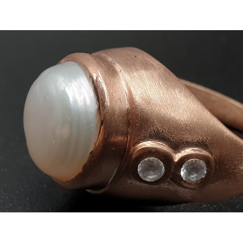 1058 - A 10ct Pearl ring in sterling silver with topaz accents in rose gold finish. ring size R