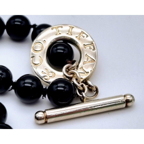 226 - A Tiffany and Co Black Onyx and Silver Clasp Necklace. Onyx beads - 6mm. 44cm. Comes in a Tiffany bo... 