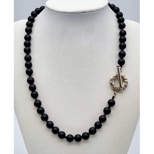 226 - A Tiffany and Co Black Onyx and Silver Clasp Necklace. Onyx beads - 6mm. 44cm. Comes in a Tiffany bo... 