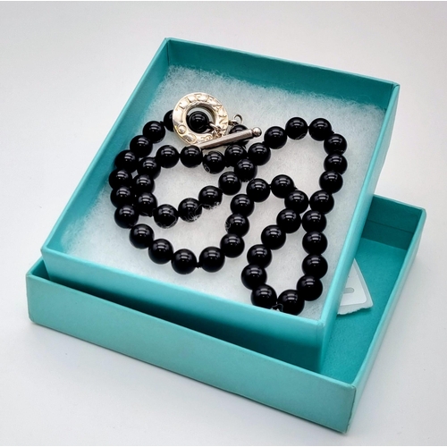 226 - A Tiffany and Co Black Onyx and Silver Clasp Necklace. Onyx beads - 6mm. 44cm. Comes in a Tiffany bo... 