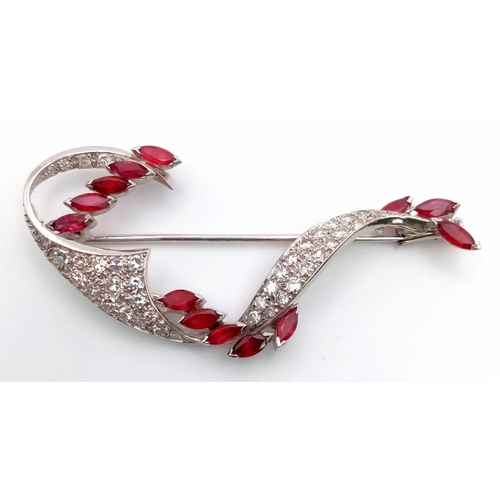 273 - A Vintage 18K White Gold Diamond and Ruby Brooch. 13 rubies on a wave of diamonds. 6 x 3cm. 7.3g tot... 