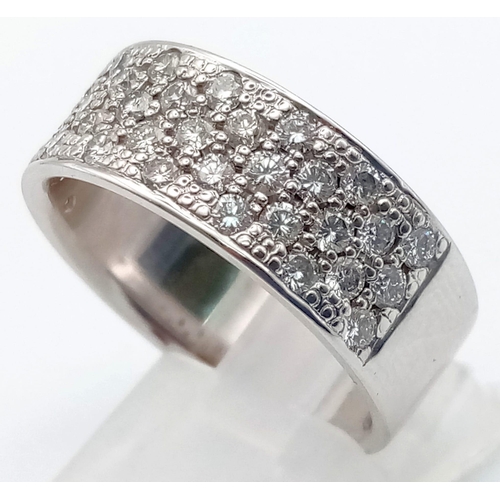 29 - An 18K White Gold Diamond Pave Diamond Band Ring.
38 small brilliant round-cut diamonds in a 3-2 con... 