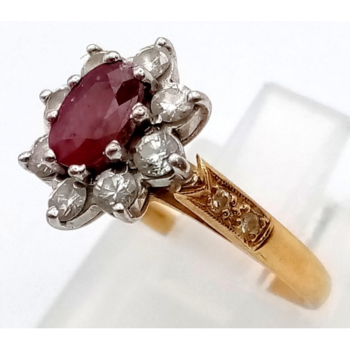 337 - An 18 K yellow gold ring with an oval cut ruby surrounded by a halo of diamonds (0.40 carats). Ring ... 