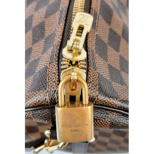 71 - A Louis Vuitton Keepall Bandouliere Travel Bag. Checked canvas design with brown leather and gilded ... 