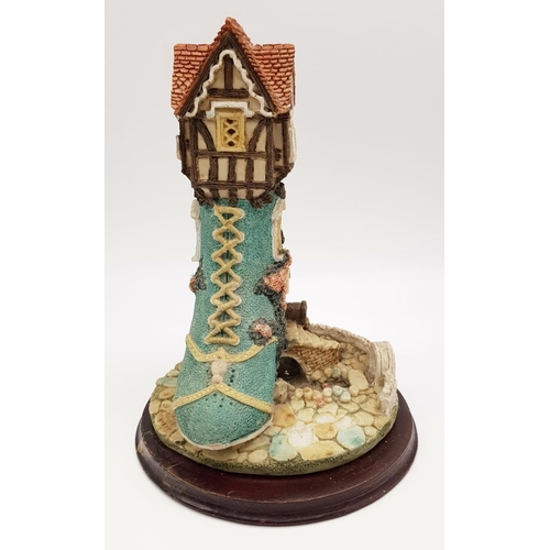 955 - There was an Old Woman that Lived in a Shoe Decorative Piece. On wooden stand. 18 x 25cm.