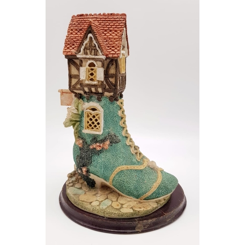 955 - There was an Old Woman that Lived in a Shoe Decorative Piece. On wooden stand. 18 x 25cm.