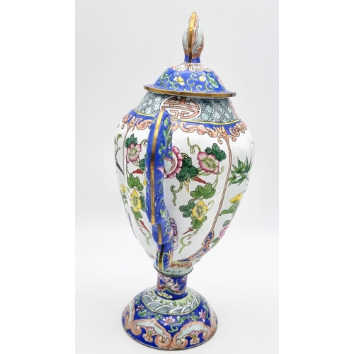 613 - An antique Chinese enamel large coffee pot. 28cm tall. 26cm wide.